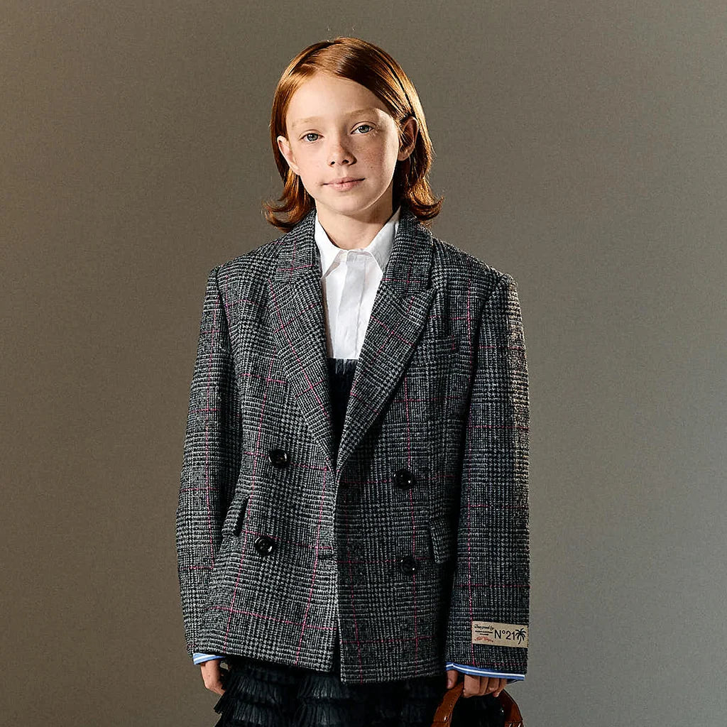 A girl wearing a checked blazer by N°21.