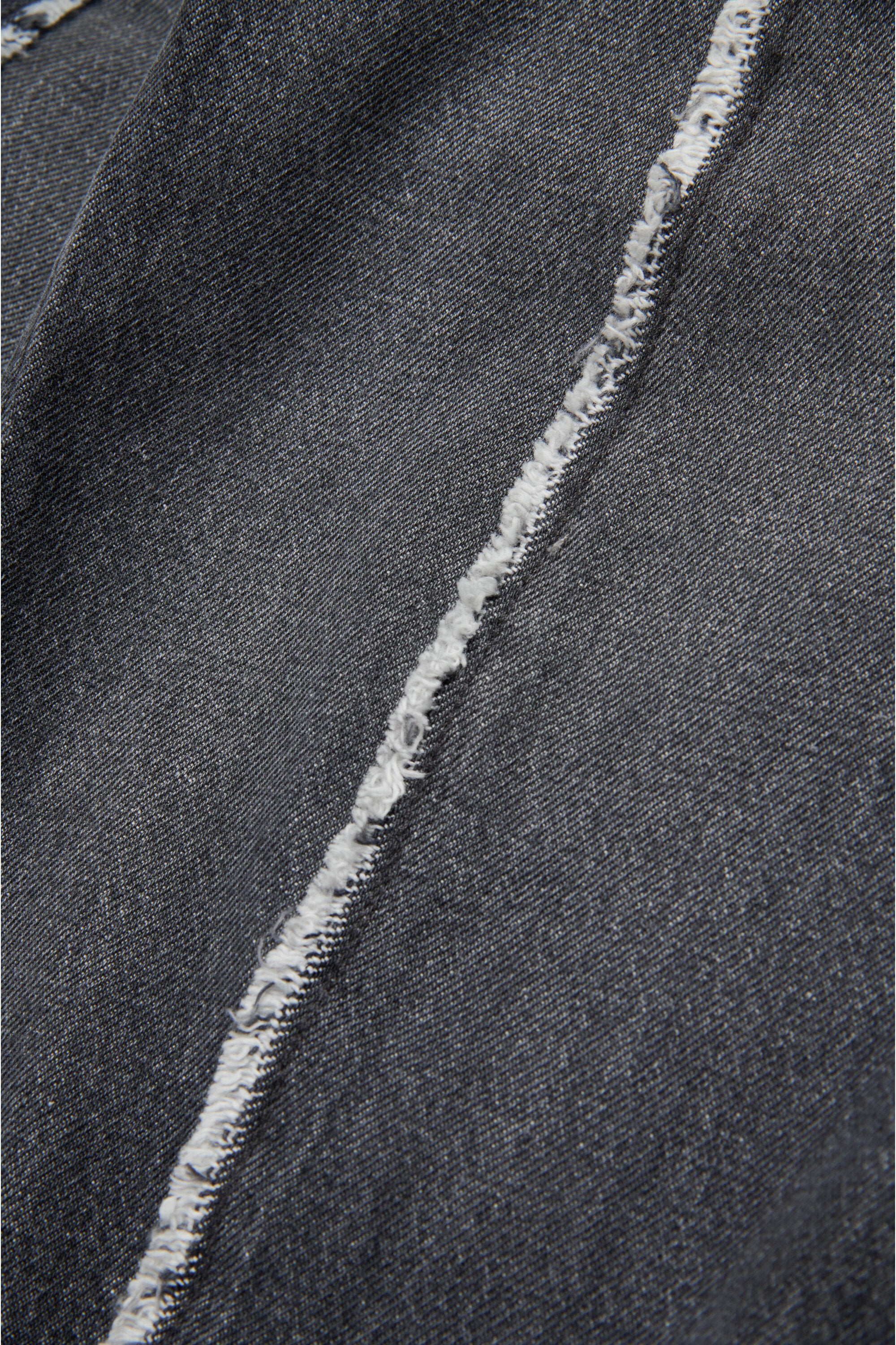 Black jeans with raw cut details