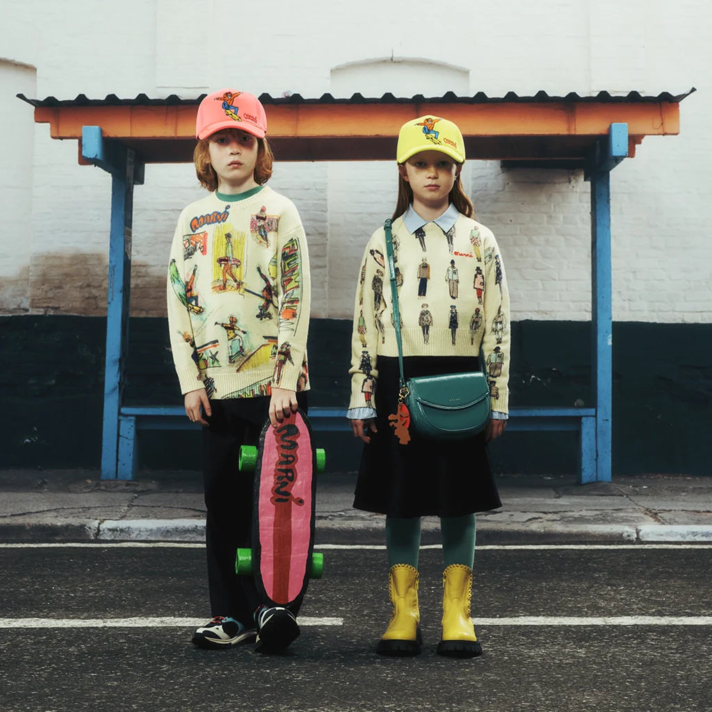 A boy and a girl standing with cool and colorful outfits by Marni.