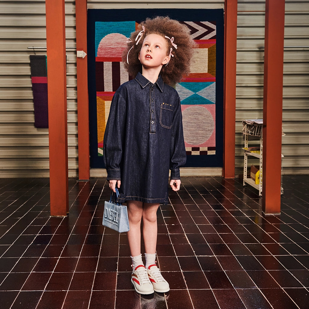 A girl with a cool denim dress and a denim bag