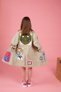 Beige gabardine trench with graffiti and printed faces
